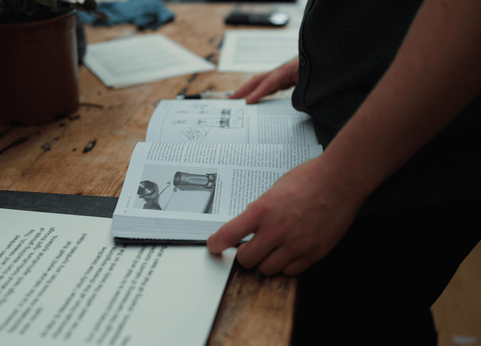 Reading a plant-science reference in the studio