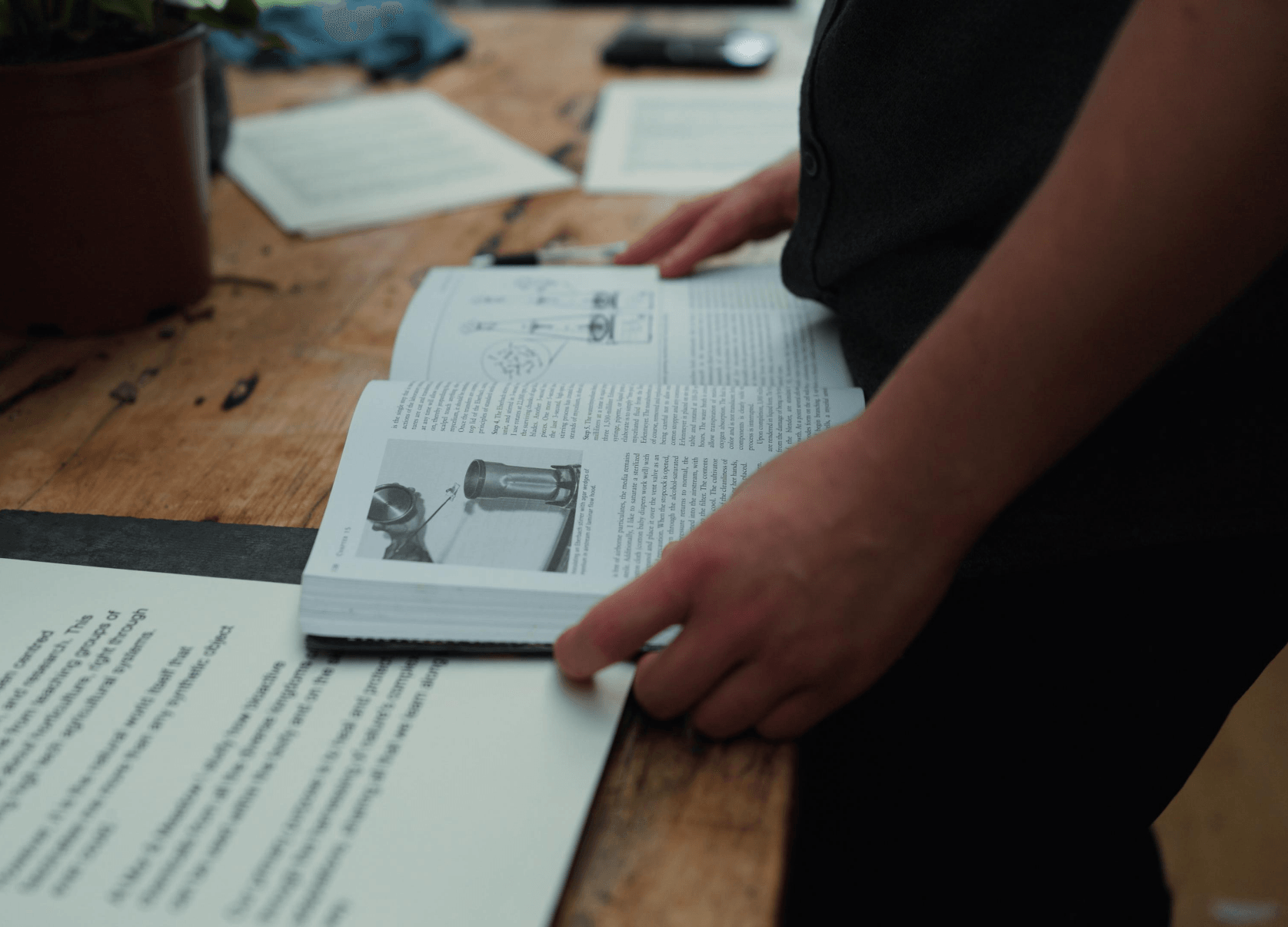 Flipping through a plant-science reference in the studio